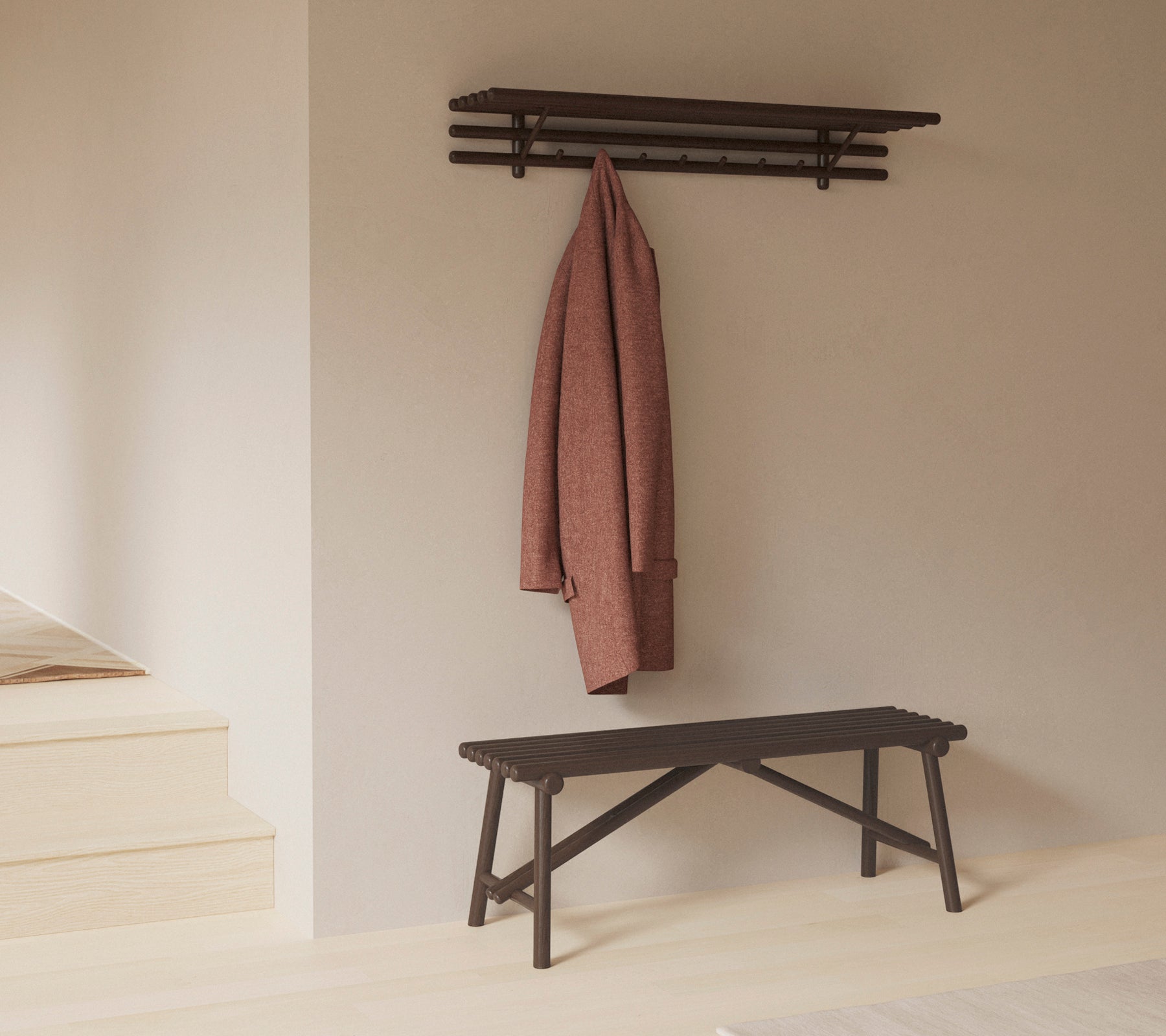 En minimalistisk bænk med en hylde over, der viser en frakke hængende på kroge, der understreger enkelhed og funktionalitet i designet.