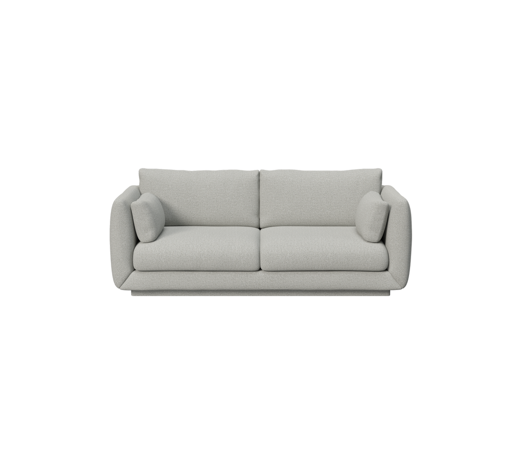 Lys grå sofa med minimalistisk design og runde puder.