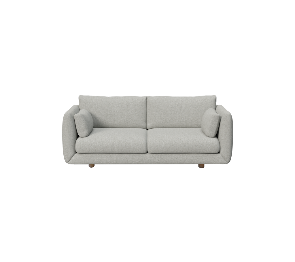 Lys grå moderne sofa med runde puder i et minimalistisk design.