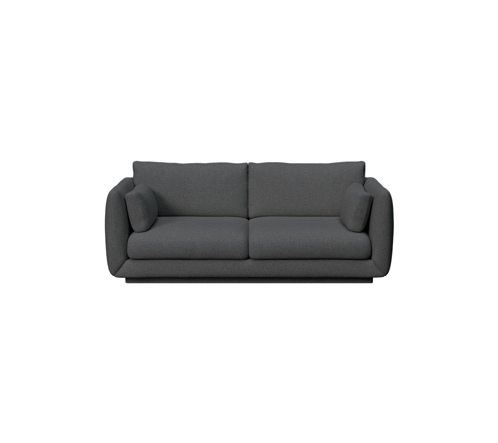 Moderne mørkegrøn sofa med puder.