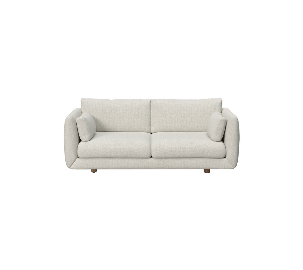Moderne sandsofa med runde puder og træben.