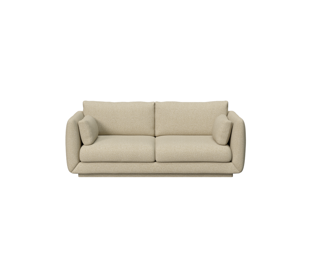 Lysebrunt sofa med runde kanter og to puder.
