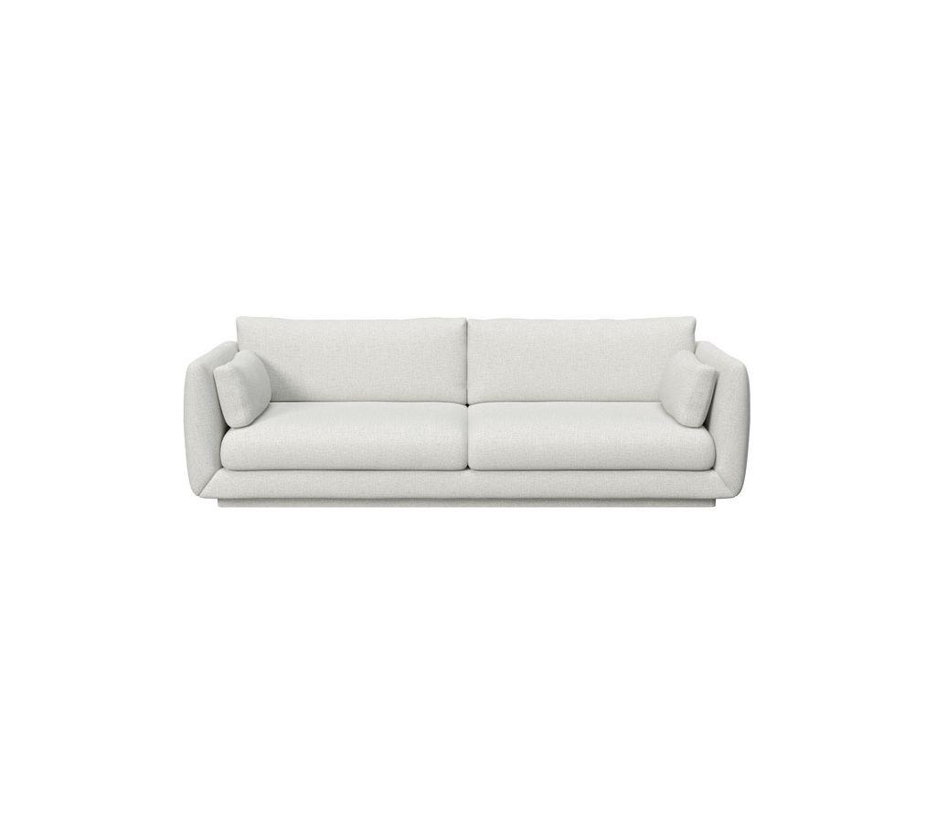 Lys grå sofa med to runde puder i et moderne design.