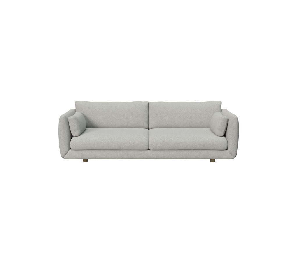 Lys grå moderne sofa med runde puder.
