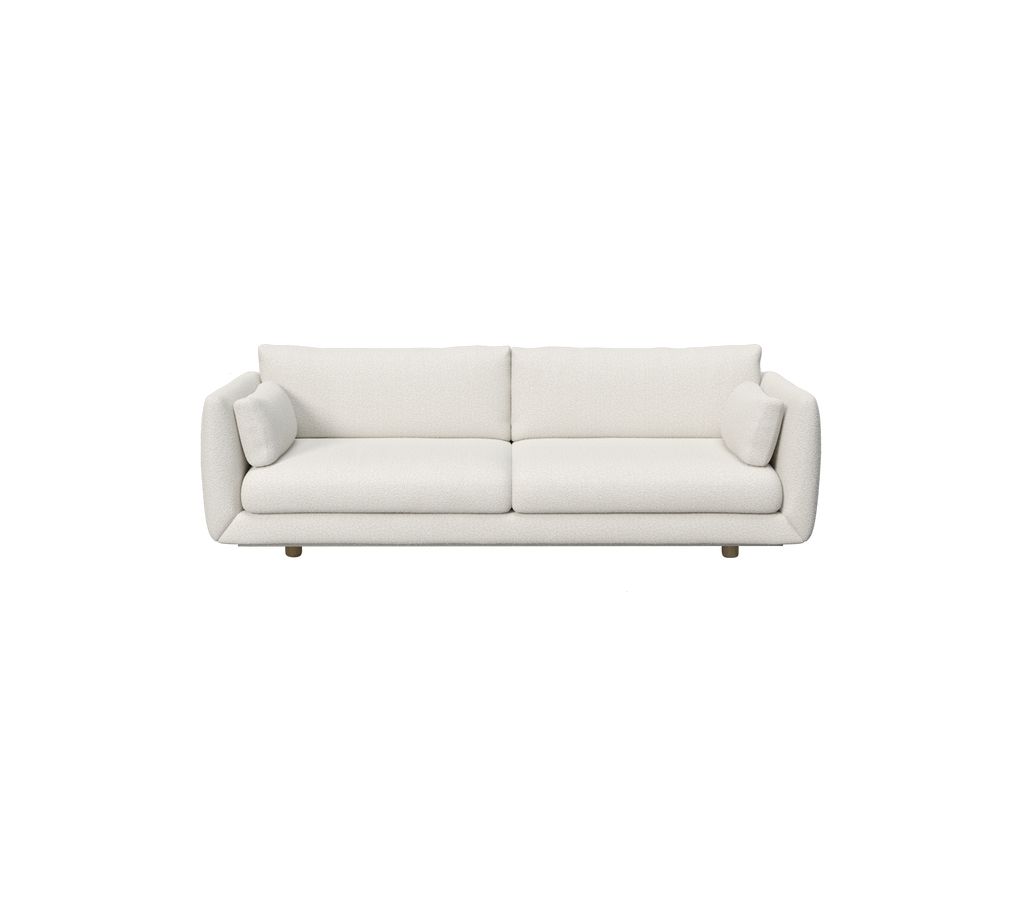 Moderne hvid sofa med cylindriske puder.