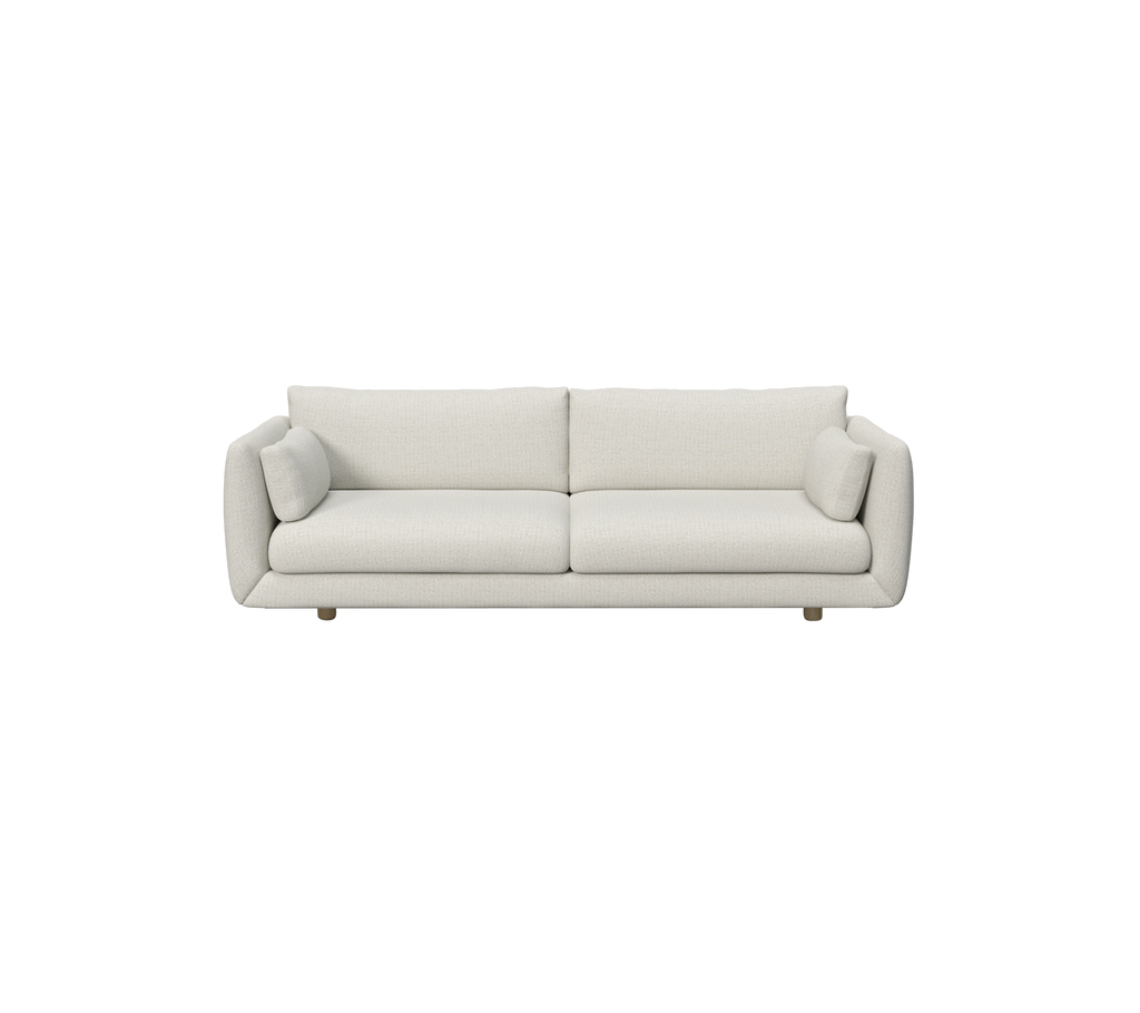 Moderne sandfarvet sofa med runde puder.