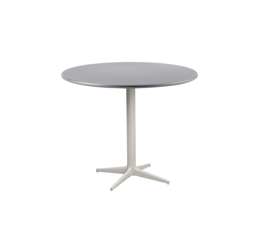 Moderne rundt bord med en glat grå top og en robust, lyse farvet base med et firebenet design.