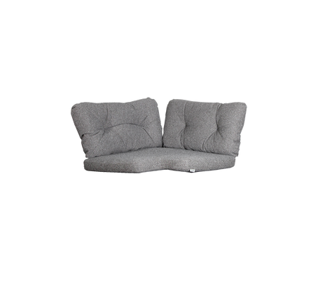 Grå to-personers lounge med bløde puder, der har et moderne design og en buet form for komfort og stil.