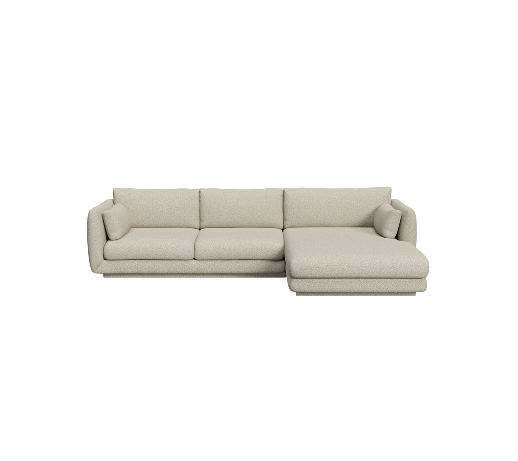 Lysbrun sektionel sofa med minimalistisk design.