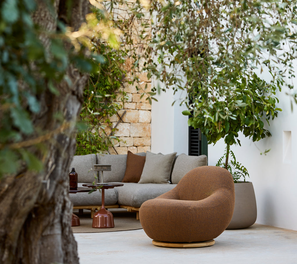 Moderne loungeområde med en brun stol og en grå sofa.